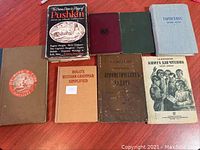 All 8 books laid out on table showing covers and titles, including Russian, English and possibly Romanian text.