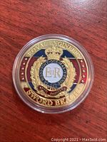 Photo of one side of the coin showing Royal Engineers crest with enamel color and inscriptions