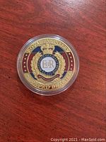 Front side of the gold plated Royal Engineers collector coin showing the Royal Engineers badge with crown, wreath, and inscriptions.