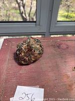 Front view of the raw garnet specimen on a red surface