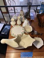 Lot of Lenox and holiday glass arranged on table showing all items for condition and details.