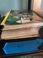 Stack of approximately 50 comic books with a visible cover of John Byrne's Next Men.