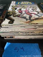 Side view showing a stack of approximately 30 H.A.R.D. Corps comic books with varied condition and visible wear.