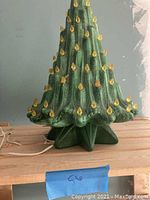 Porcelain Christmas tree with yellow candle light inserts, some missing, scratches visible on surface