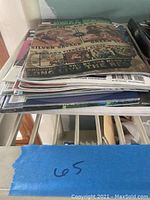 Stack of 12 comic books showing assorted titles and colors, with focus on the top Planet Hulk Gladiator Guidebook issue