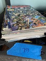 Stack of 22 comic books showing the top New Men comic with colorful cover art featuring multiple characters.
