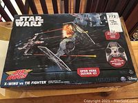 Front of box with Star Wars Air Hogs X-Wing vs TIE Fighter drone battle set, packaging intact and in good condition