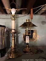 Both brass base lamps shown side by side; one with harp but no shade, one with loose metal shade attached.