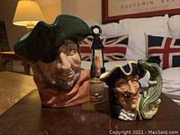 Front view of Smuggler and Captain Hook jugs side by side showing detailed faces and handles