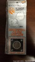 Front of sealed packaging showing the coin and Edmonton Oilers logo with Wayne Gretzky featured.