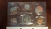 Front side of uncirculated 1971 Canadian coin set featuring British Columbia Centennial silver dollar and six other coins in sealed packaging.