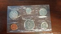 Photo showing one sealed plastic holder containing 7 Canadian 1979 coins with silver and copper colors.