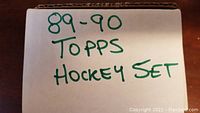 Photo of cardboard box labeled '89-90 Topps Hockey Set' in green marker indicating the lot contents