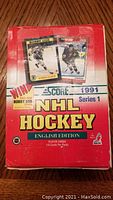 Front of original cardboard box for 1991 Score NHL Hockey Series 1 English Edition hockey cards, showing images of hockey player cards and box condition.