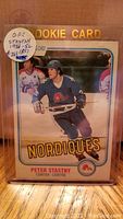 Front of 1981-82 OPC Peter Stastny rookie card in plastic holder showing player action photo and team name Nordiques.