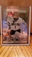 Front of 2013-14 Prizm Jack Campbell rookie card showing player in Dallas Stars goalie uniform with holographic design.