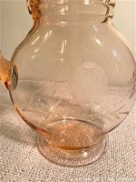 Close-up showing the delicate corn flower etching design on the pink glass body of the pitcher.