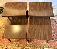 Overhead view of the two vintage side tables showing rectangular wood grain tops with offset upper tiers.