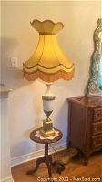 Full view of the antique lamp showing base, shade and fringe