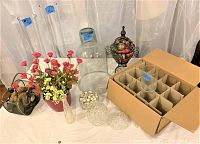 Overall view of the lot showing assortment of glass cloches, jars, vase with flowers, and decorative basket with colorful balls.