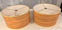 Two drum lamp shades with wood grain pattern, shown side by side