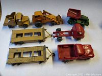 Top view of seven die-cast vehicles showing front with yellow car and vehicle types.