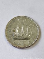 Front side of the 1949 Canadian silver dollar featuring the Bluenose schooner and the year 1949.