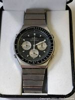 Front view of watch in display box showing dial, bezel and bracelet