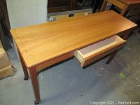 Full view of the wood hall table showing drawer and tabletop surface.