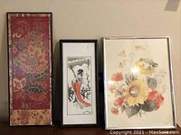 Four framed art pieces displayed together showing various Japanese characters and floral artwork.