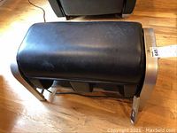 Panasonic EP30102 foot and calf massager black leather ottoman with metal frame, showing scratches on top surface