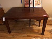 Full top view of the rectangular wooden table showing the surface and leg design