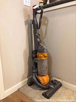 Dyson Ball vacuum upright in corner