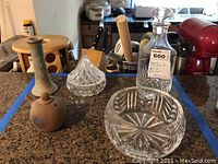 Image showing Waterford crystal bowl, crystal decanter with stopper, and multiple clay pottery items on kitchen counter