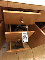 Open drawers showing hair dryer and other electric hair styling tools inside.