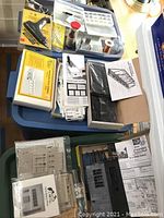 Full lot overview showing various HO scale kits including truss bridge and modeling tools in their packaging on tables.