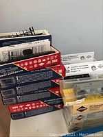 Stack of red and blue Blueprint Series boxes containing unassembled HO scale boxcar kits