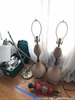 Overview showing two ceramic lamps, adjustable task lamp, red lantern and box of lamp parts