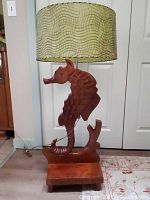 Full view of the seahorse lamp with shade and base showing overall shape and color.