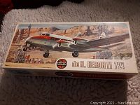 Box top displaying artwork of a De Havilland Heron II airplane in flight with Airfix branding and model scale (72nd).