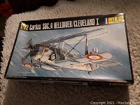 Box top showing the illustrated artwork of the Curtiss SBC.4 Helldiver/Cleveland I aircraft with 1/72 scale branding and Heller logo.