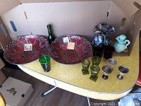 Full lot overview showing arrangement of various glassware and ceramic pieces on table