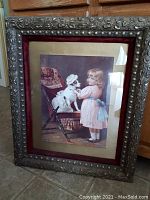 Full view of the framed Victorian print showing the girl with the dog in a carriage inside the gilt frame with burgundy velvet inner lining.