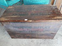 Top view of the wooden crate showing aged wood and stenciled text.