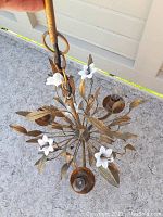 Top view of chandelier showing three arms, leaf details, and porcelain flowers