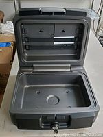 Open view of the interior of the Sentry Safe showing removable tray and interior compartments, key lock visible below.