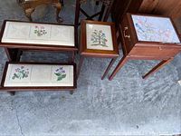 View of all three wooden furniture pieces including bed steps and two side tables showing their cross stitch tops