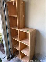 Tall and shorter wooden shelves positioned side by side