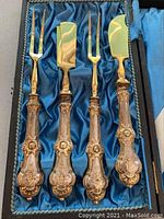 Four-piece Victorian cutlery set in presentation case with blue satin lining