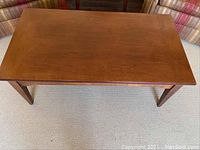 Top view of wooden coffee table showing smooth surface and finish.